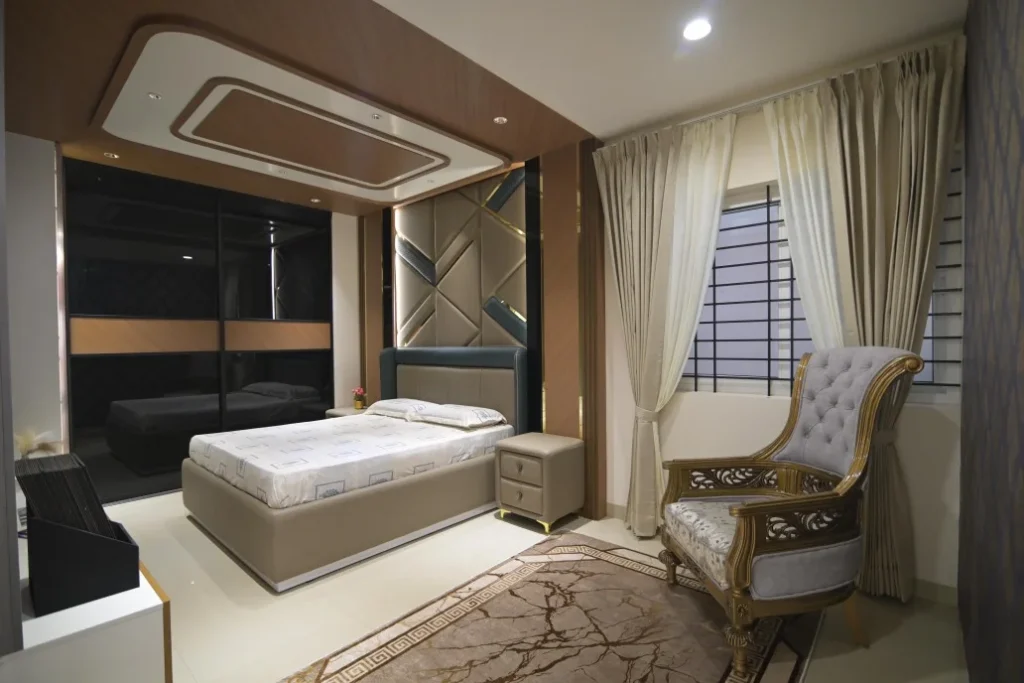 Modern luxury bedroom interior with upholstered bed, wooden ceiling design, sliding wardrobe, and elegant curtains